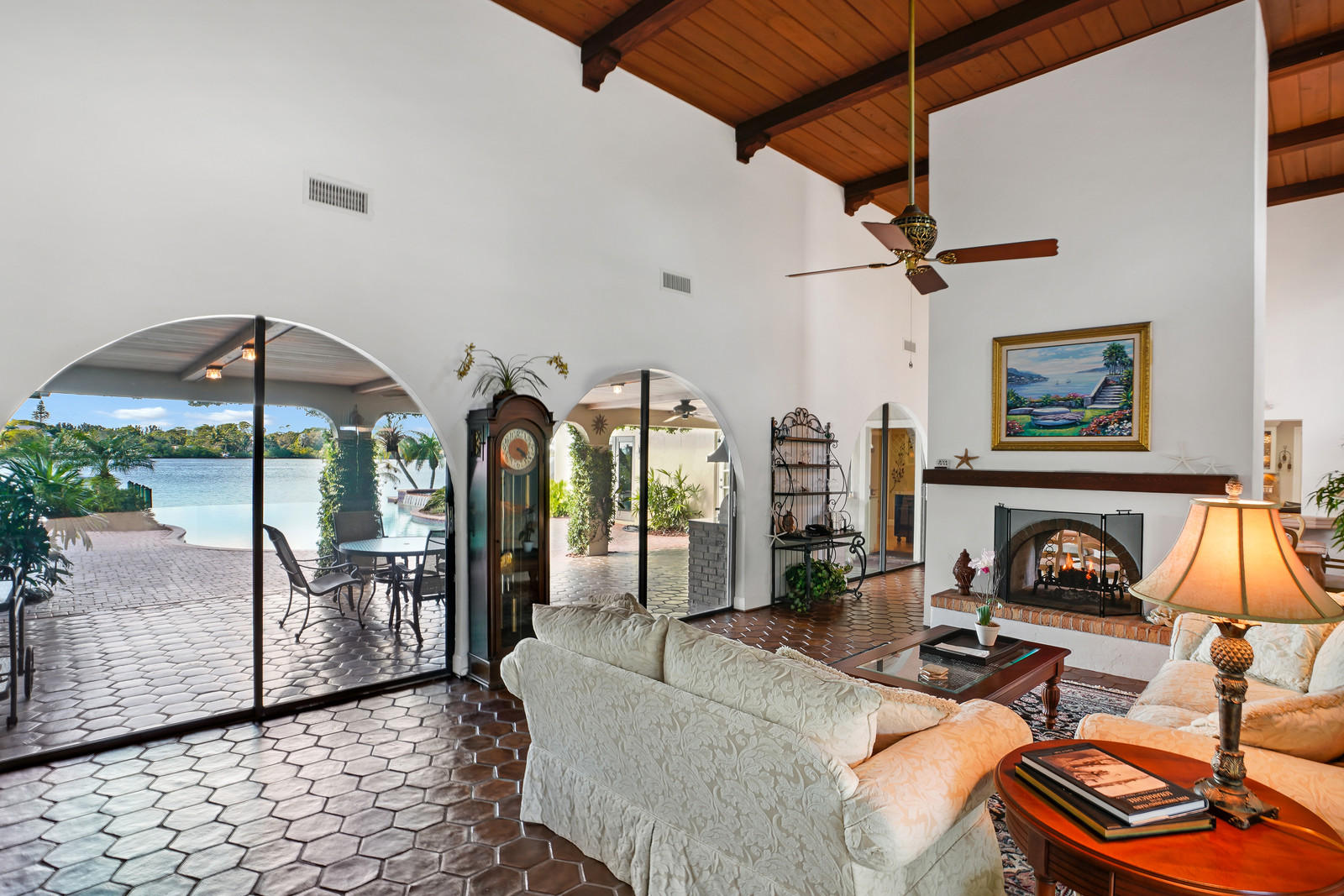 143 Point Circle Tequesta, FL 33469 - Photo 17 of 41 a living room with furniture a flat screen tv and a fireplace