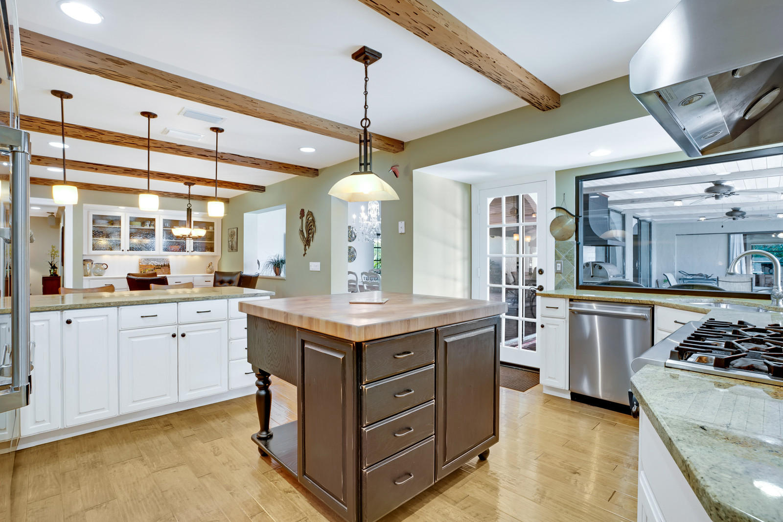 143 Point Circle Tequesta, FL 33469 - Photo 22 of 41 a kitchen with a stove window and cabinets