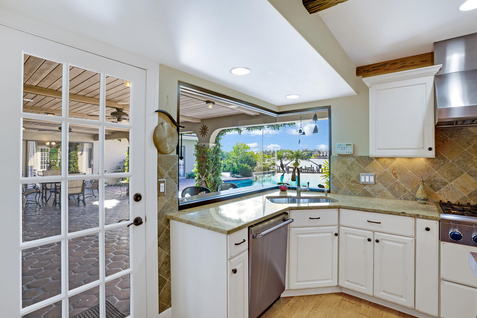 143 Point Circle Tequesta, FL 33469 - Photo 24 of 41 a kitchen with a sink and large window