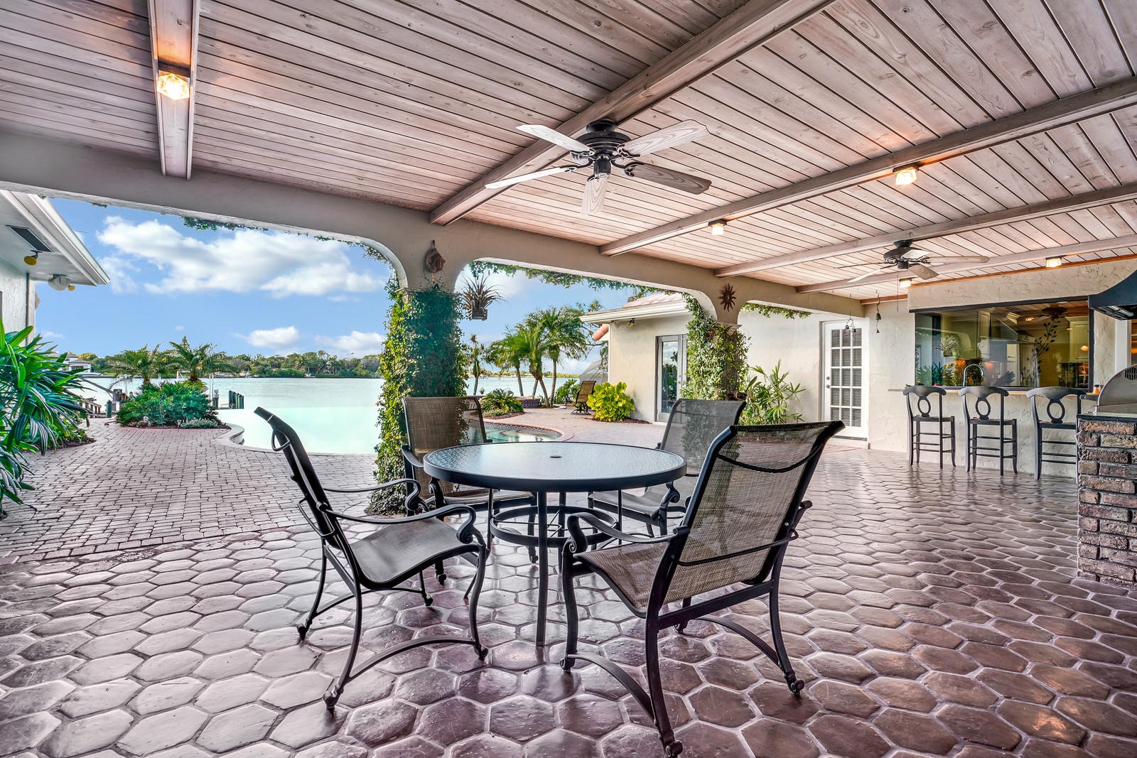 143 Point Circle Tequesta, FL 33469 - Photo 27 of 41 a view of a patio with a table and chairs