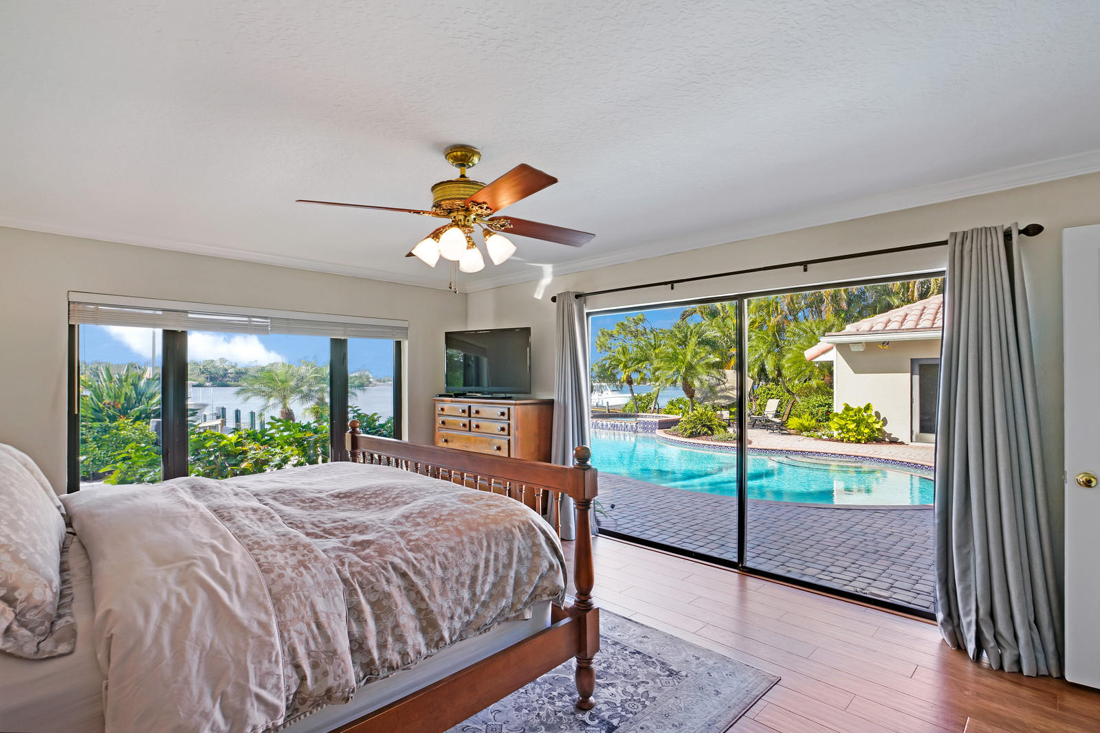 143 Point Circle Tequesta, FL 33469 - Photo 31 of 41 a bedroom with a large bed and a large window