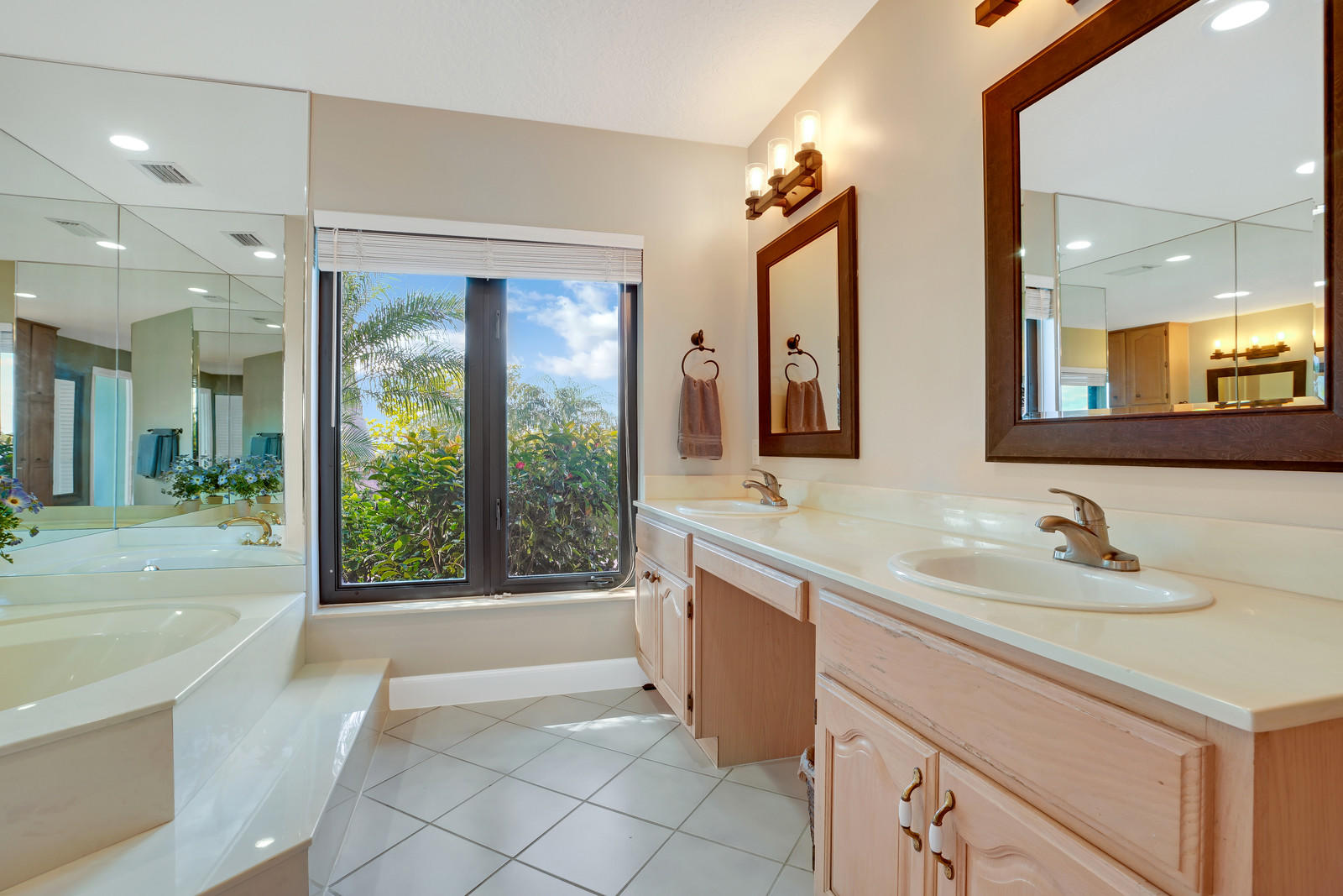 143 Point Circle Tequesta, FL 33469 - Photo 33 of 41 a spacious bathroom with a sink mirror and a bathtub