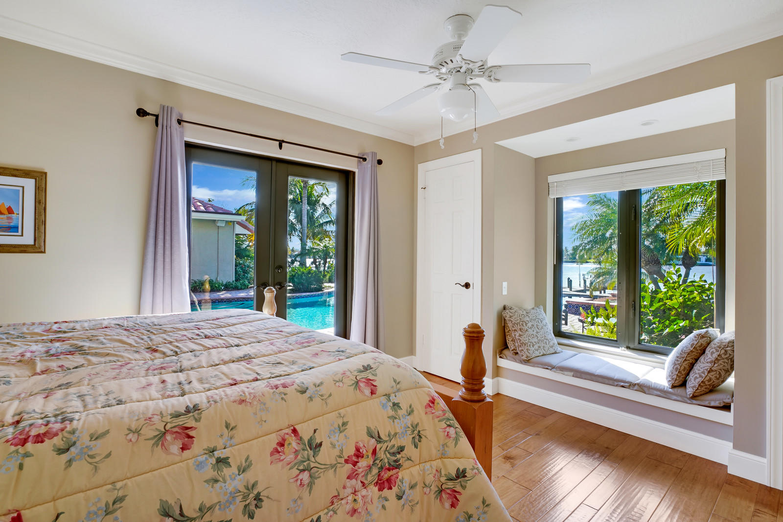 143 Point Circle Tequesta, FL 33469 - Photo 36 of 41 a bedroom with a bed and a large window with outer view