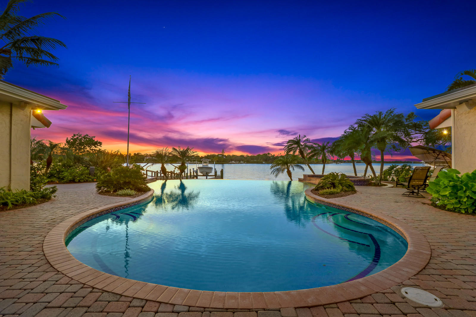 143 Point Circle Tequesta, FL 33469 - Photo 4 of 41 a view of a swimming pool with an outdoor seating