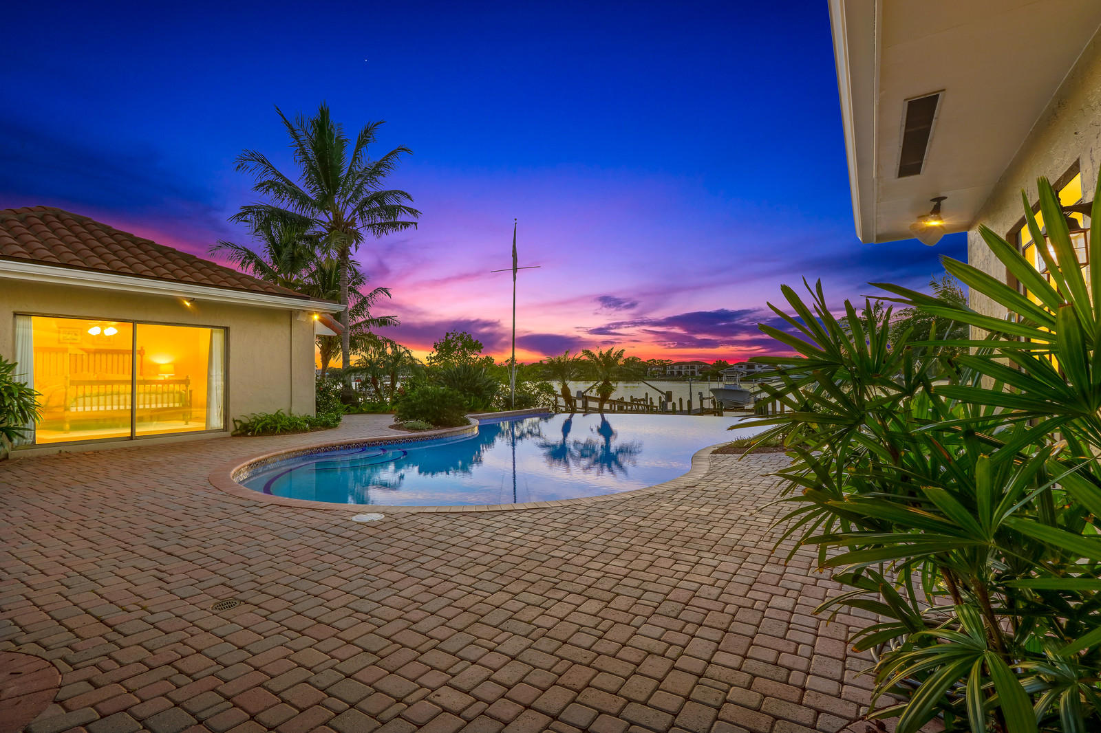 143 Point Circle Tequesta, FL 33469 - Photo 7 of 41 a view of a swimming pool with a table and chairs
