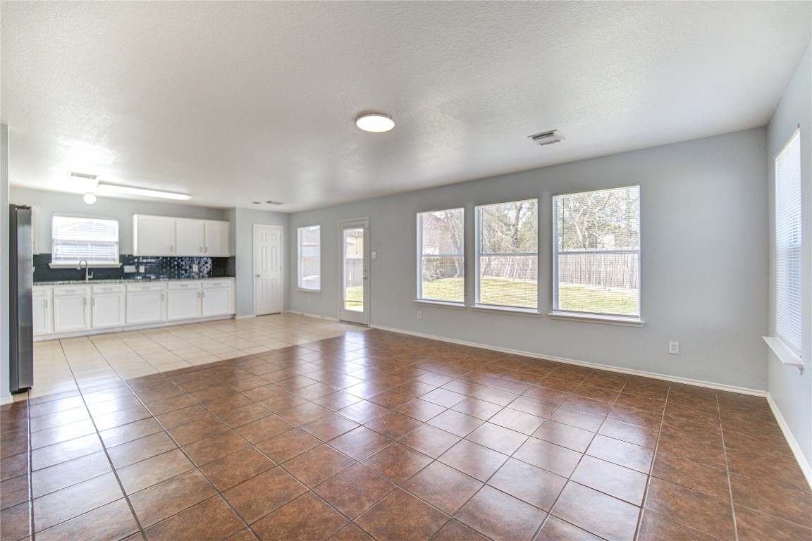 22919 Twisting Maple Court Spring, TX 77373 - Photo 15 of 49 a view of an empty room with kitchen and window