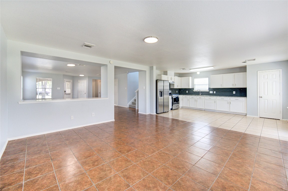 22919 Twisting Maple Court Spring, TX 77373 - Photo 16 of 49 a view of a kitchen with a sink and a refrigerator