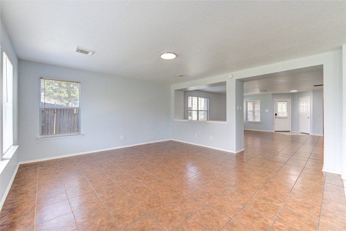 22919 Twisting Maple Court Spring, TX 77373 - Photo 17 of 49 a view of an empty room with a window and wooden floor