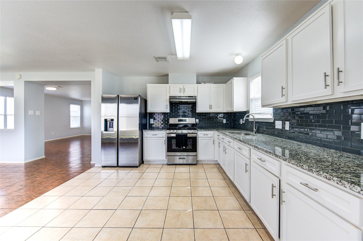 22919 Twisting Maple Court Spring, TX 77373 - Photo 23 of 49 a large kitchen with cabinets