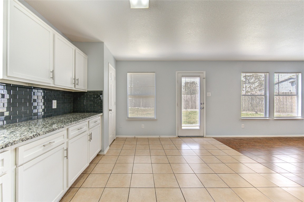 22919 Twisting Maple Court Spring, TX 77373 - Photo 25 of 49 a view of an empty room with a kitchen and a window