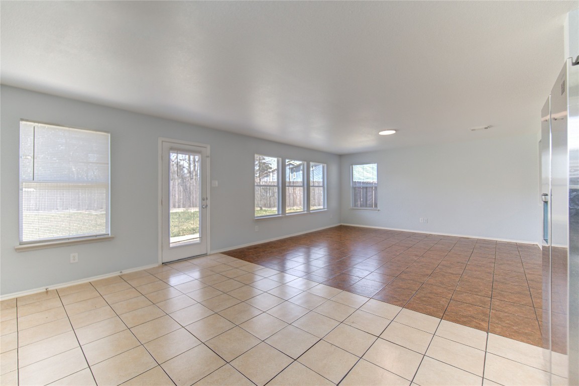 22919 Twisting Maple Court Spring, TX 77373 - Photo 26 of 49 a view of an empty room with window and chandelier fan