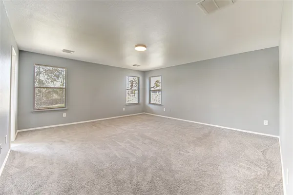 an empty room with windows and closet