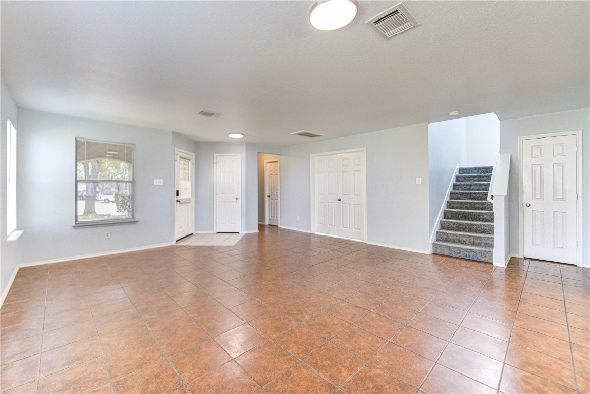 22919 Twisting Maple Court Spring, TX 77373 - Photo 8 of 49 a view of an empty room with wooden floor and stairs