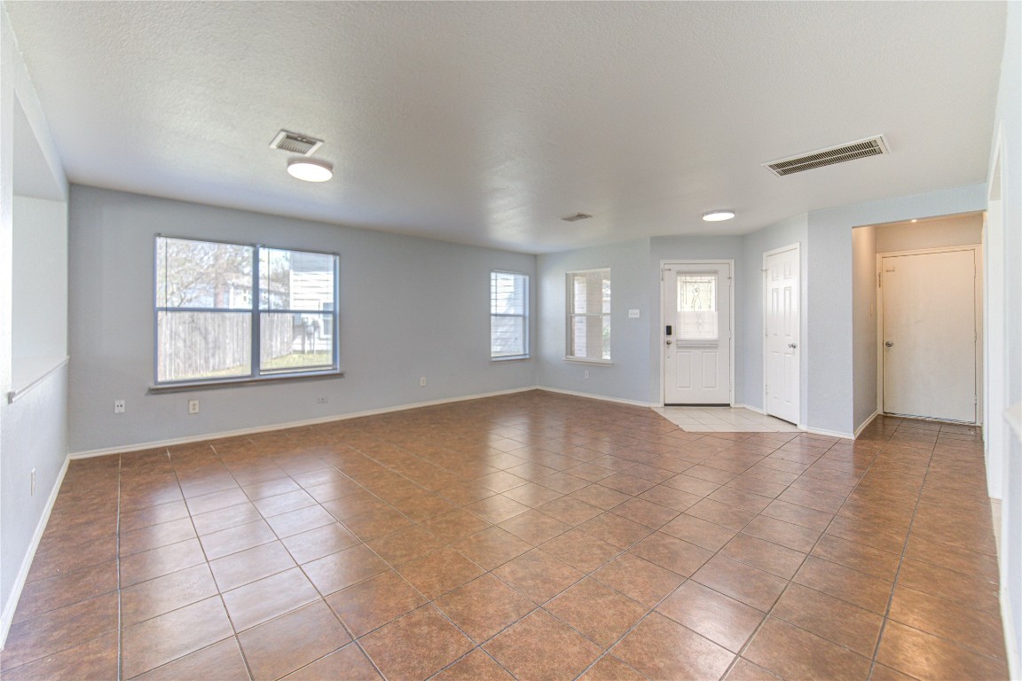 22919 Twisting Maple Court Spring, TX 77373 - Photo 9 of 49 an empty room with windows and entrance