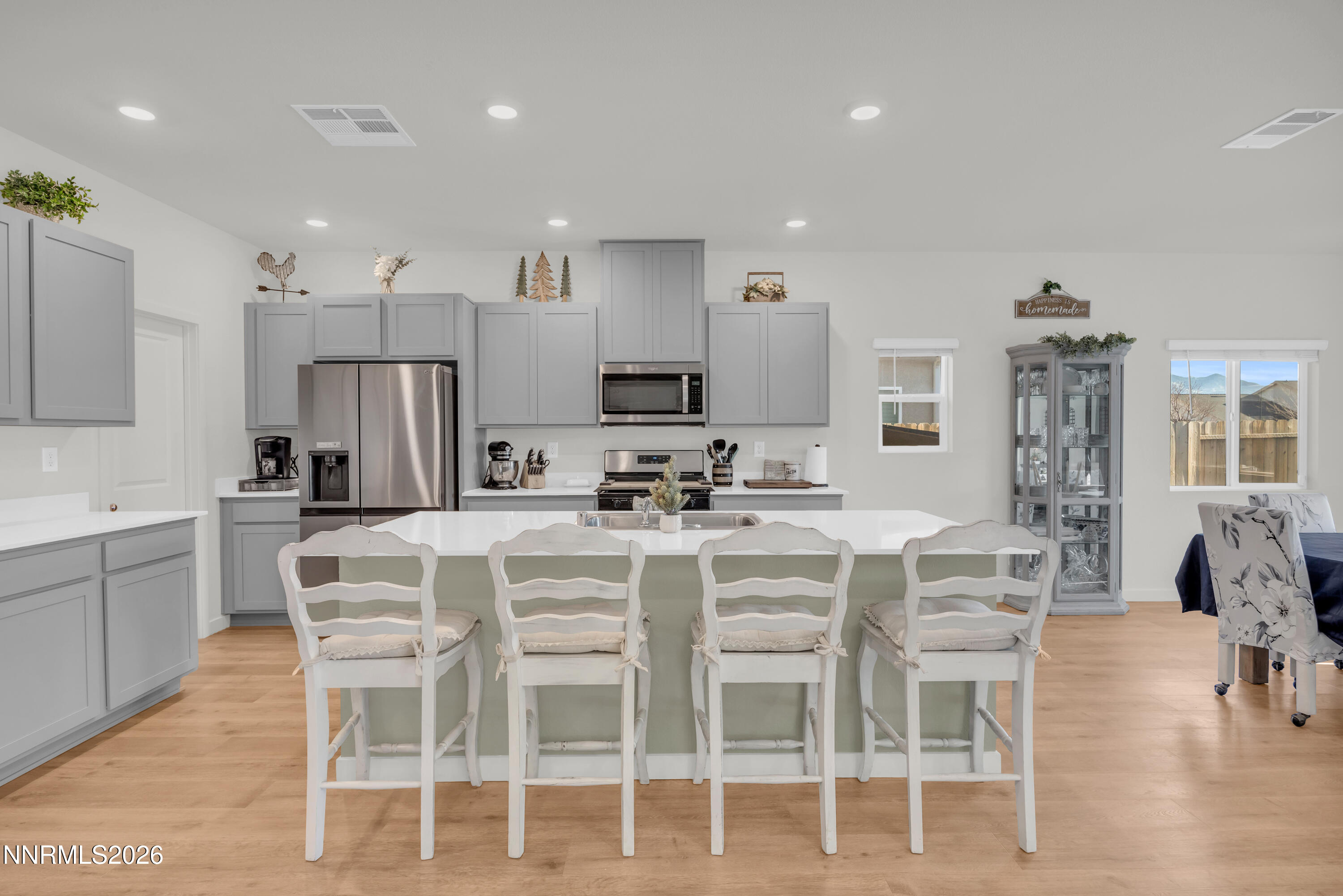737 Butte Crk Road Dayton, NV 89403 - Photo 3 of 34 a kitchen with a dining table cabinets and stainless steel appliances