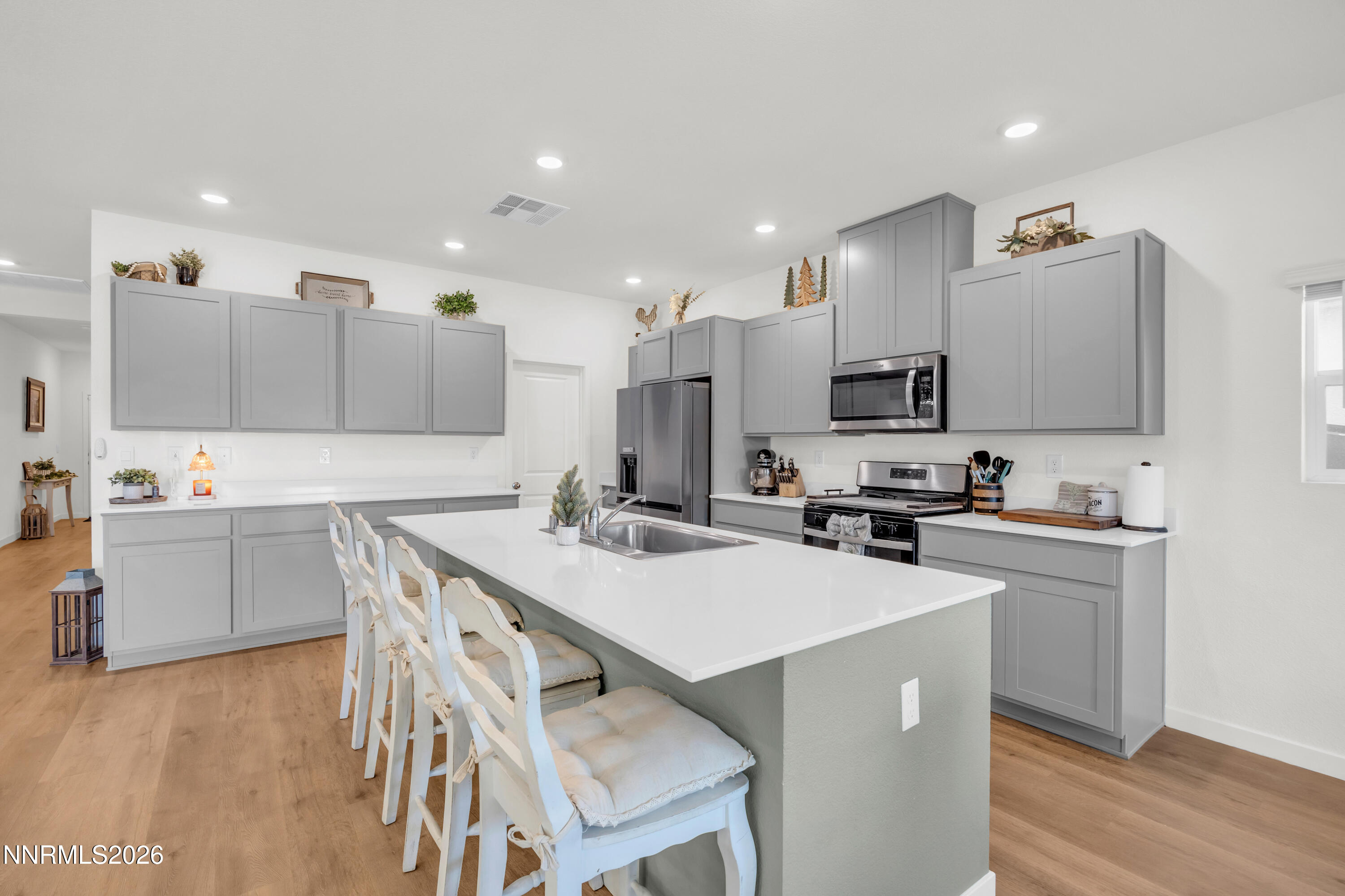 737 Butte Crk Road Dayton, NV 89403 - Photo 6 of 34 a kitchen with cabinets a sink dishwasher a stove and a refrigerator with wooden floor