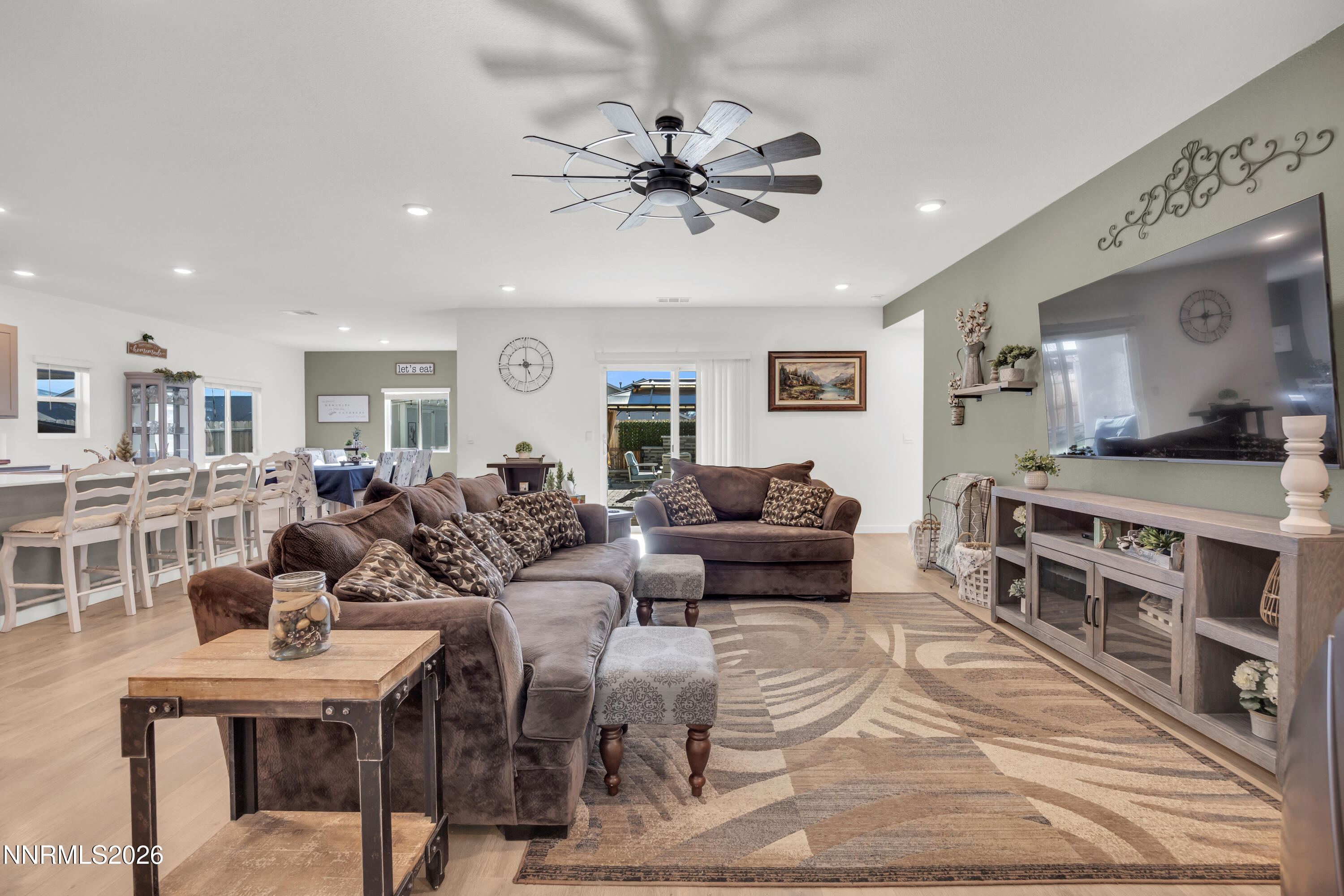 737 Butte Crk Road Dayton, NV 89403 - Photo 10 of 34 a living room with furniture a chandelier and a dining table with wooden floor