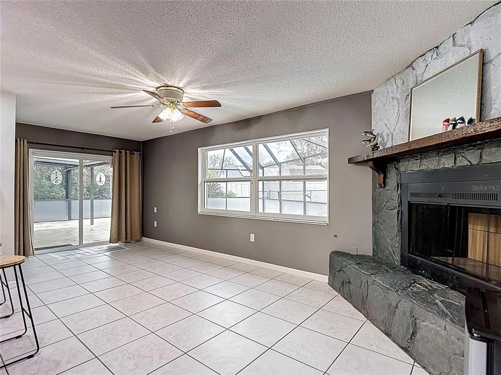 9171 Vicksburg Road Spring Hill, FL 34608 - Photo 12 of 55 a bedroom with a bed and a fireplace