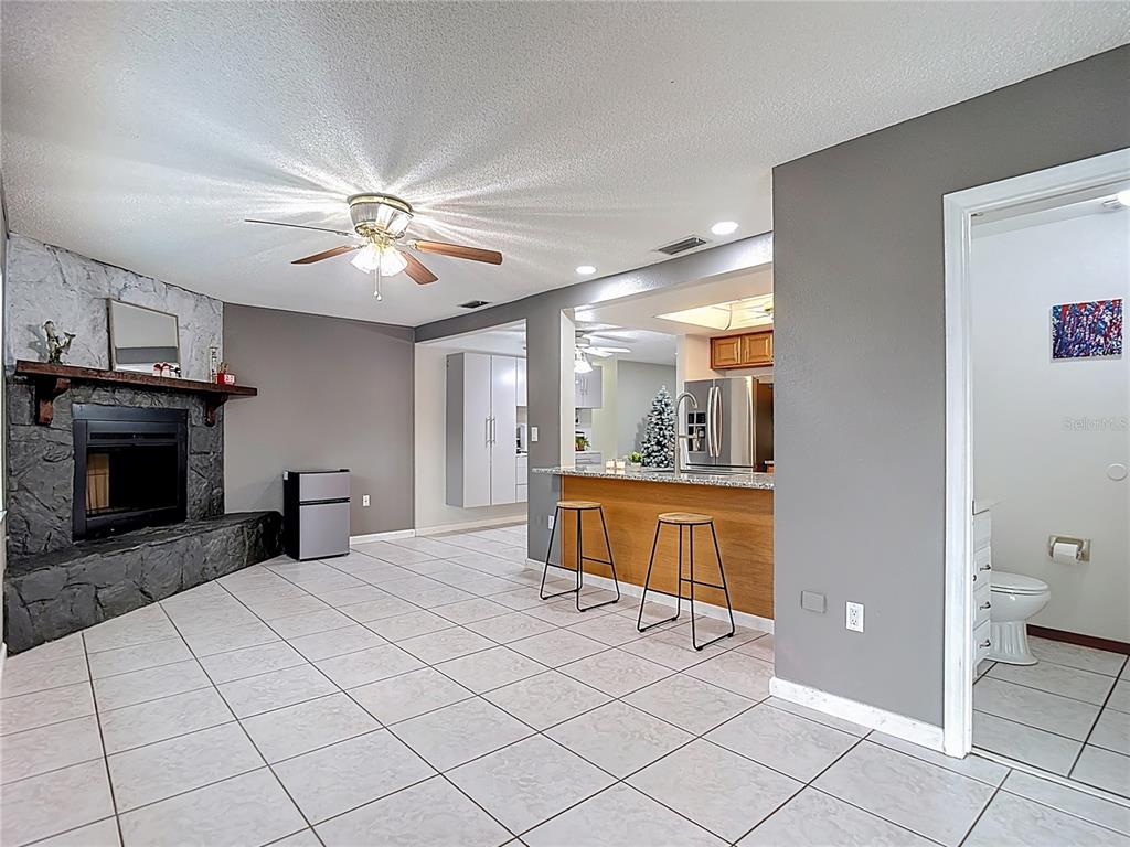 9171 Vicksburg Road Spring Hill, FL 34608 - Photo 16 of 55 a large bedroom with a large bed and a chandelier