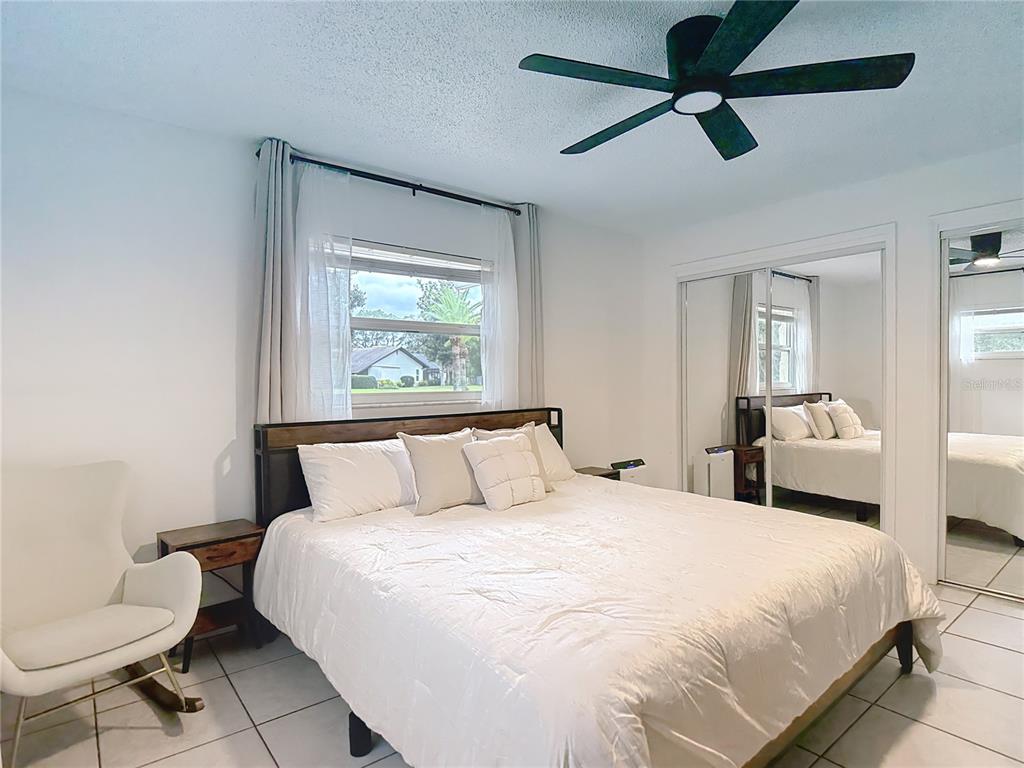 9171 Vicksburg Road Spring Hill, FL 34608 - Photo 20 of 55 a bedroom with a bed and a mirror