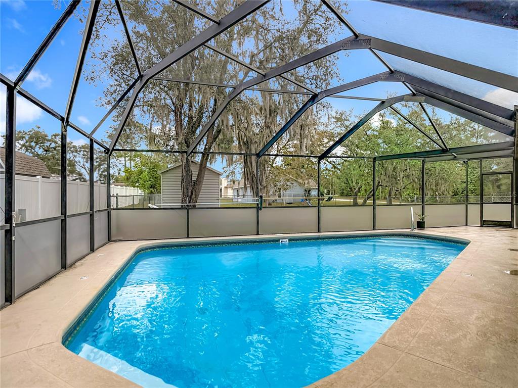 9171 Vicksburg Road Spring Hill, FL 34608 - Photo 35 of 55 a view of swimming pool with an outdoor seating