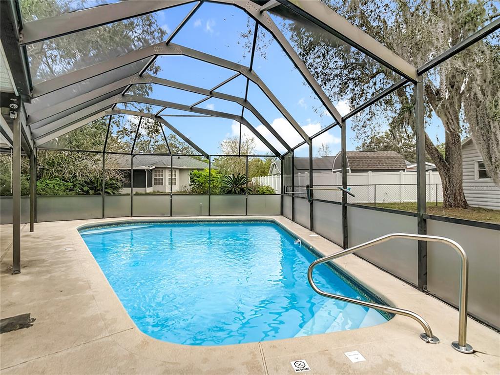 9171 Vicksburg Road Spring Hill, FL 34608 - Photo 37 of 55 a view of a swimming pool with a patio