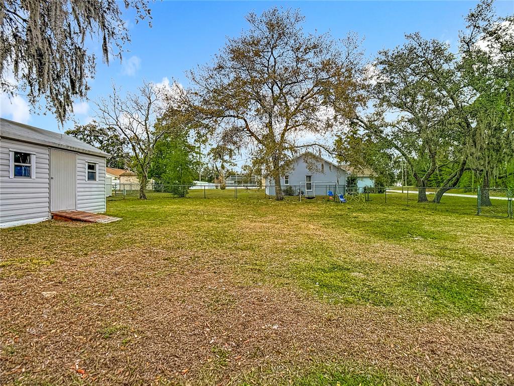 9171 Vicksburg Road Spring Hill, FL 34608 - Photo 41 of 55 a big yard with trees in the background