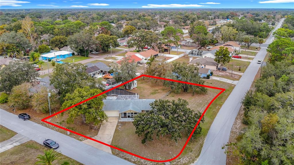9171 Vicksburg Road Spring Hill, FL 34608 - Photo 49 of 55 an aerial view of residential houses with outdoor space