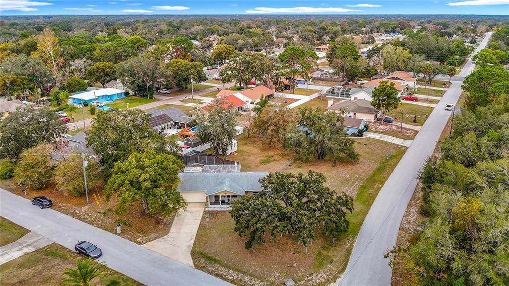 9171 Vicksburg Road Spring Hill, FL 34608 - Photo 50 of 55 an aerial view of residential houses with outdoor space