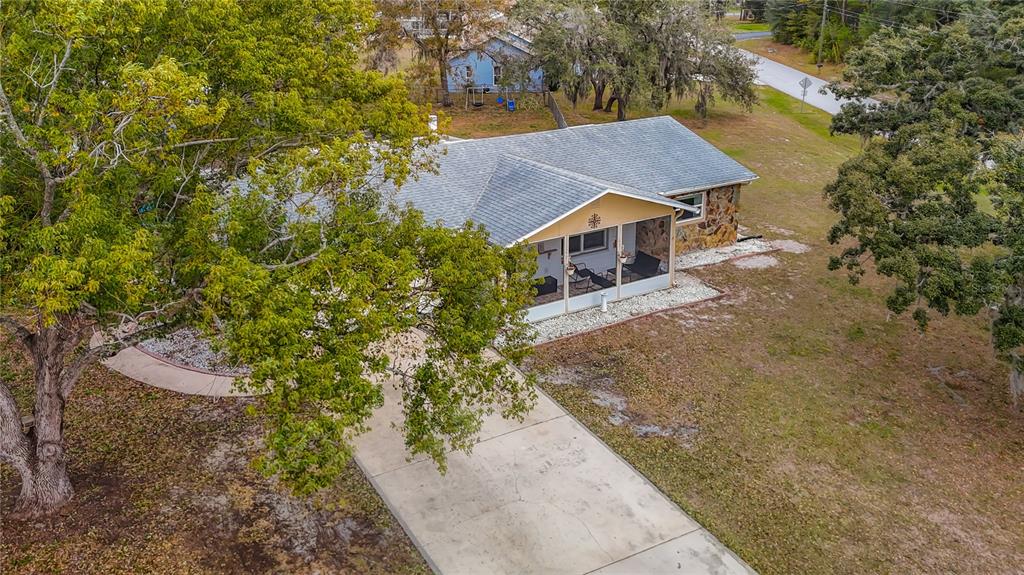 9171 Vicksburg Road Spring Hill, FL 34608 - Photo 55 of 55 an aerial view of a house with a yard and large trees