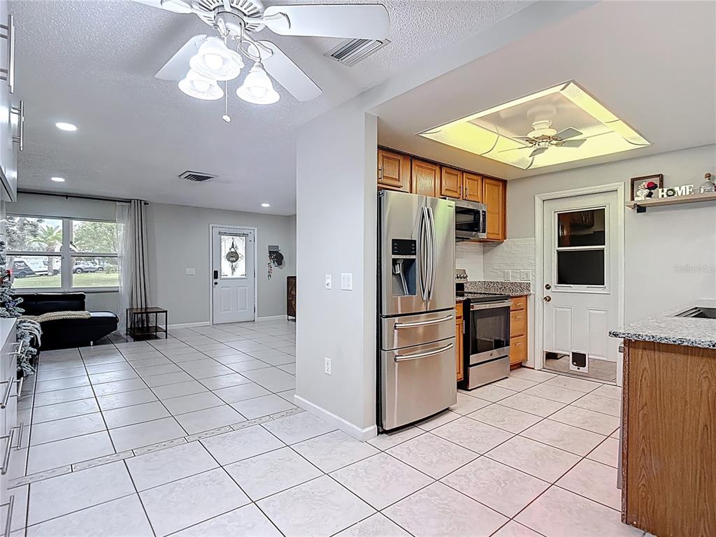 9171 Vicksburg Road Spring Hill, FL 34608 - Photo 8 of 55 a view of a kitchen with microwave and refrigerator