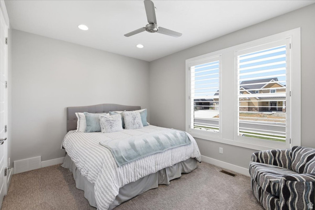 21 Pier Place Tooele, UT 84074 - Photo 43 of 112 Bright room with large windows featuring white plantation shutters, neutral gray walls, recessed lighting, and a modern ceiling fan