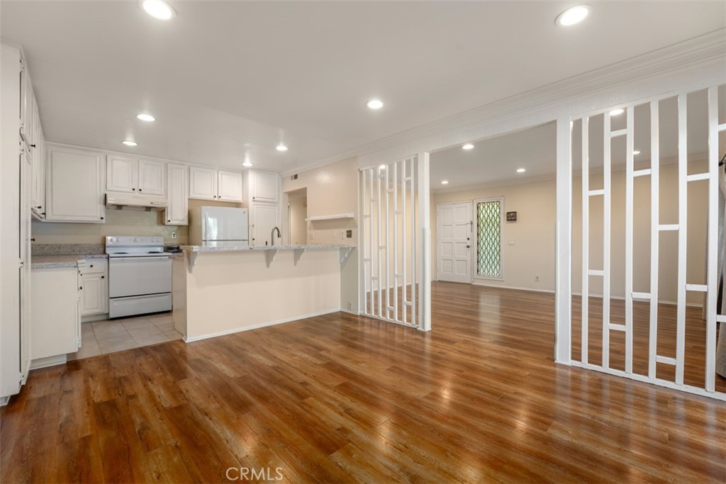 10454 Rio Grande Court Fountain Valley, CA 92708 - Photo 6 of 17 a kitchen with stainless steel appliances granite countertop a refrigerator sink and white cabinets