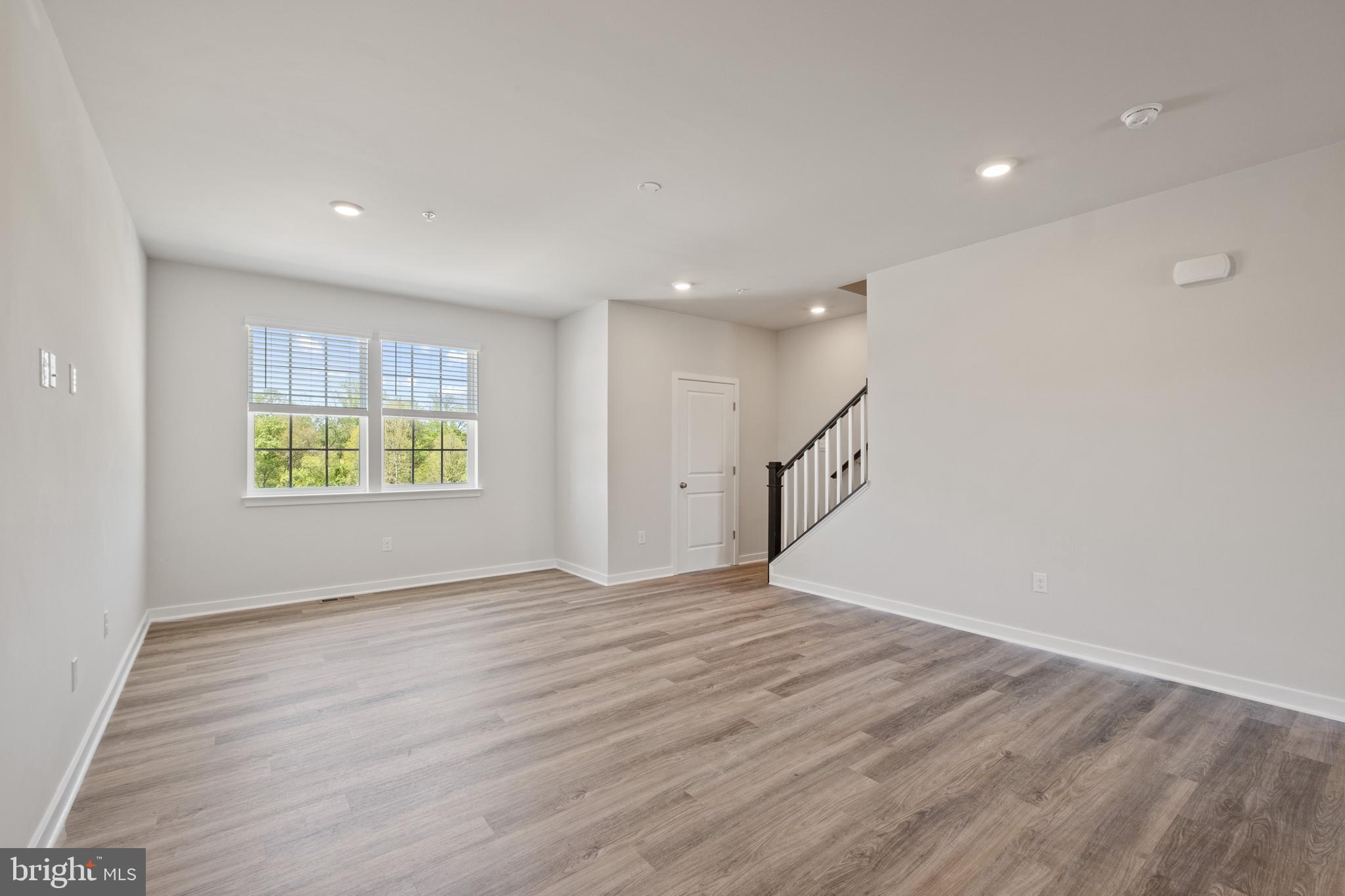 5044 Silver Oak Drive Rosedale, MD 21237 - Photo 13 of 33 a view of an empty room with wooden floor and a window