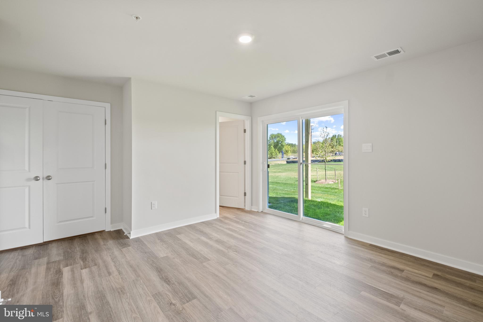 5044 Silver Oak Drive Rosedale, MD 21237 - Photo 6 of 33 a view of an empty room with wooden floor and a window