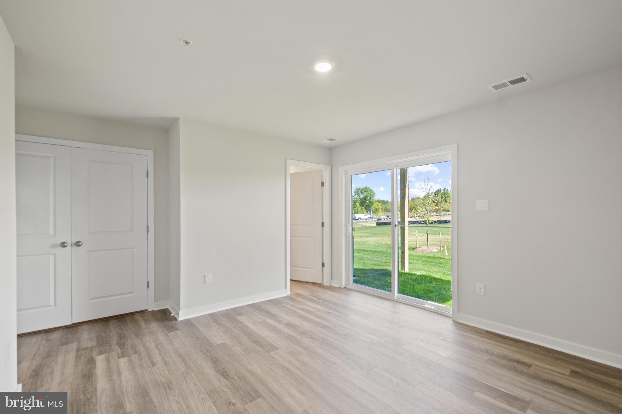 5044 Silver Oak Drive Rosedale, MD 21237 - Photo 7 of 33 a view of an empty room with a window and wooden floor