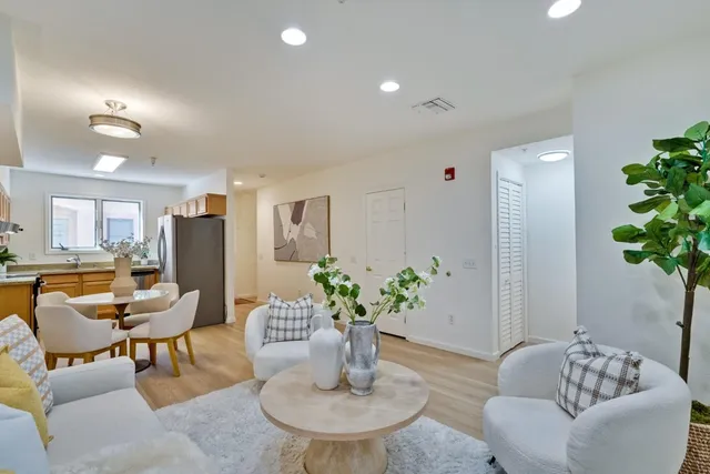 a living room with furniture and flowers