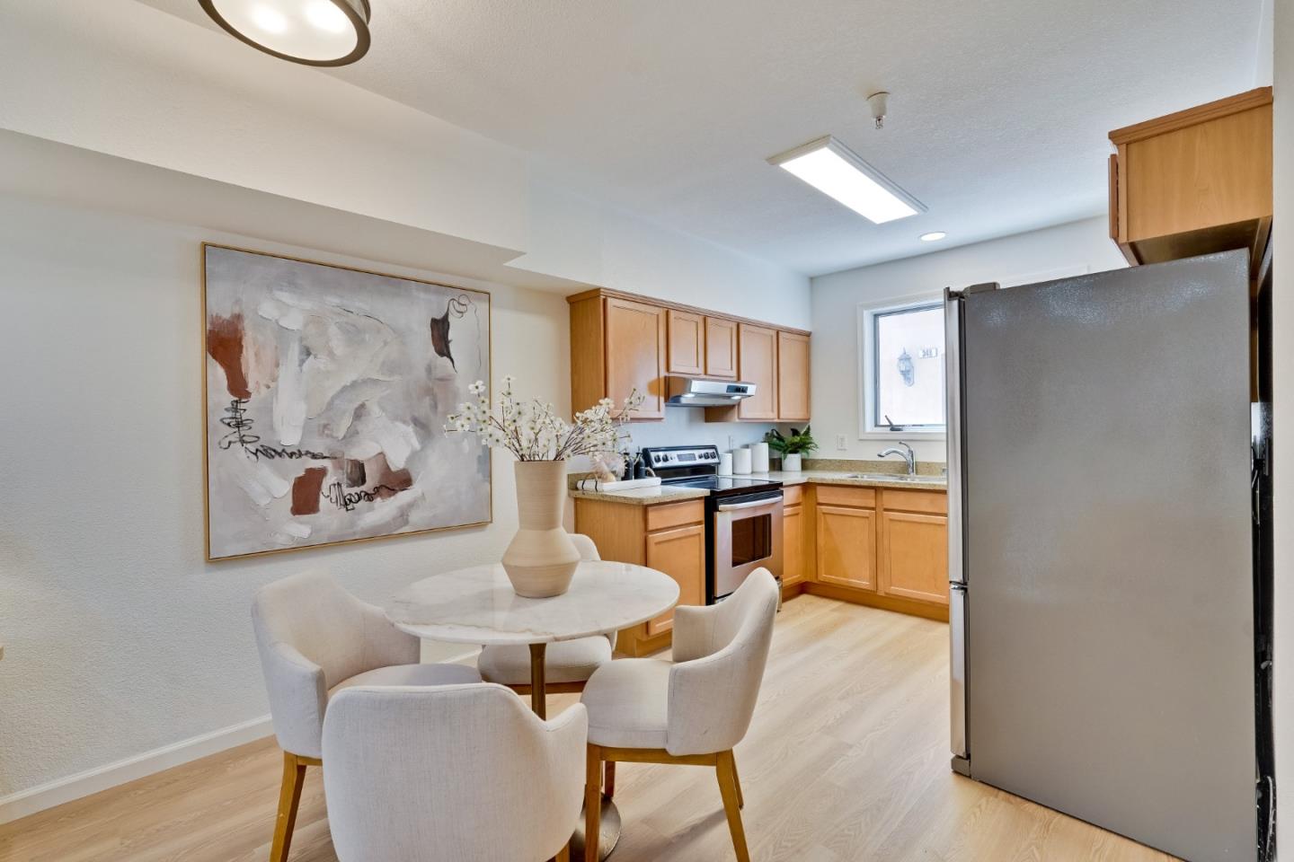 342 Bryant Street Mountain View, CA 94041 - Photo 7 of 43 a kitchen with stainless steel appliances granite countertop a refrigerator a stove a sink a dining table and chairs with wooden floor