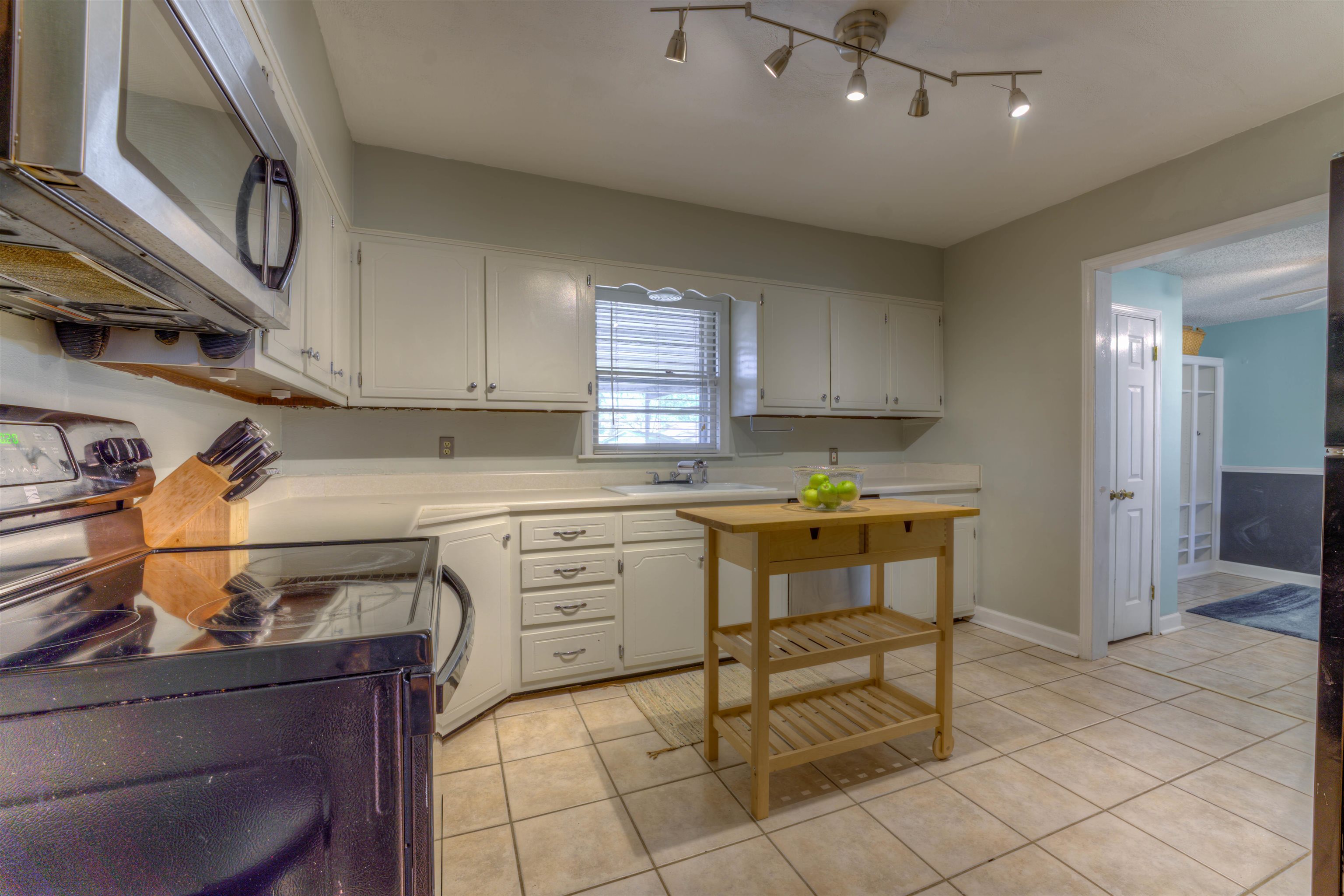 1083 Marcia Road Memphis, TN 38117 - Photo 5 of 11 a kitchen with cabinets and chairs