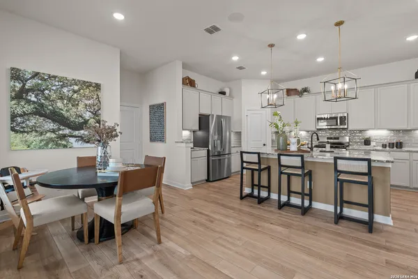 a view of kitchen with cabinets table and chairs