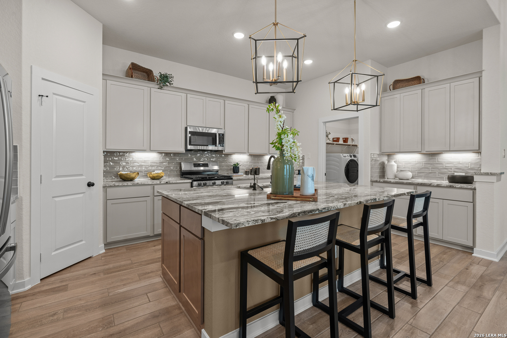 9435 Hidden Stone Schertz, TX 78154 - Photo 20 of 41 a kitchen with kitchen island granite countertop a sink cabinets and stainless steel appliances