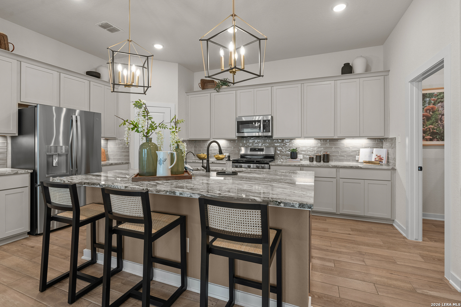 9435 Hidden Stone Schertz, TX 78154 - Photo 21 of 41 a kitchen with kitchen island granite countertop a table and chairs in it