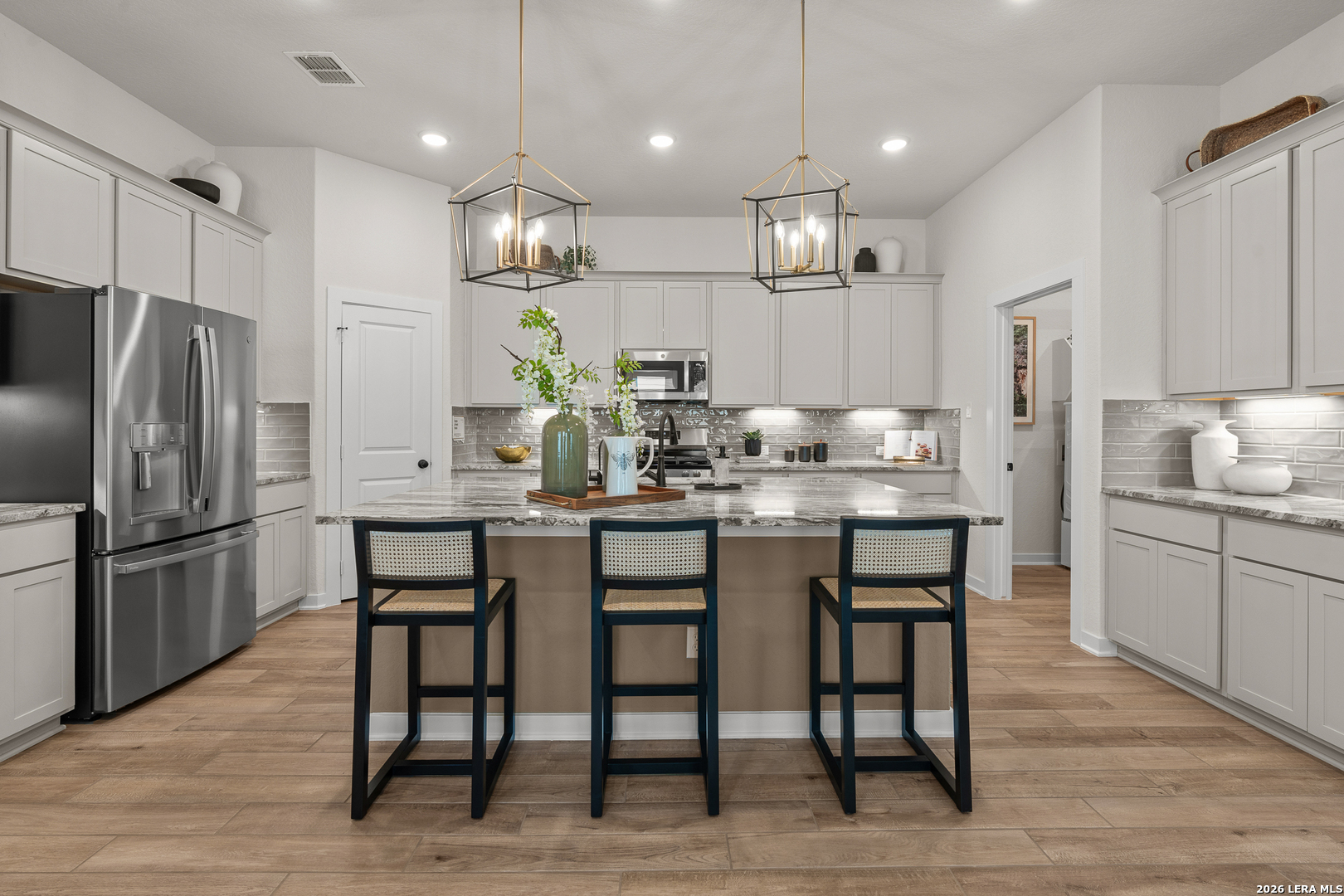 9435 Hidden Stone Schertz, TX 78154 - Photo 22 of 41 a kitchen with kitchen island granite countertop a table and chairs in it