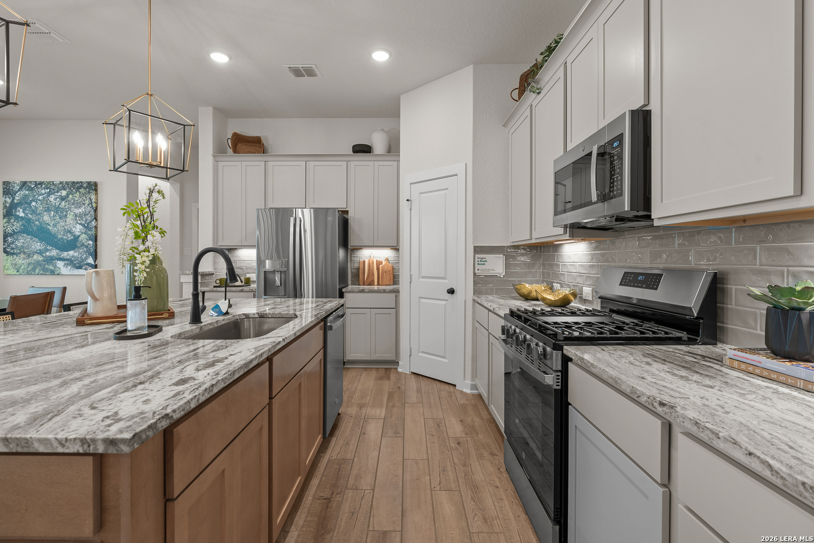 9435 Hidden Stone Schertz, TX 78154 - Photo 25 of 41 a kitchen with stainless steel appliances granite countertop a stove a sink and a microwave