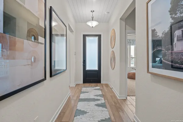 view of a hallway with wooden floor and staircase