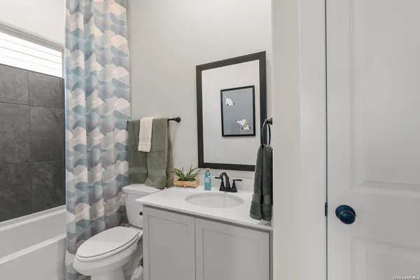 a bathroom with a sink toilet vanity and shower