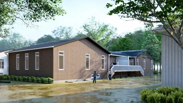 a view of a house with backyard and sitting area