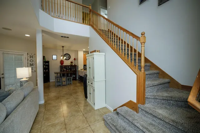 a view of staircase with white walls and furniture