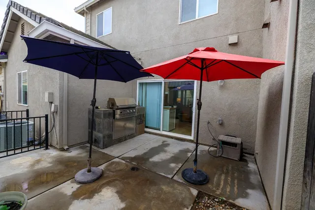 a view of a house with backyard and sitting area