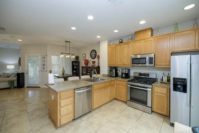a kitchen with stainless steel appliances granite countertop a sink and cabinets